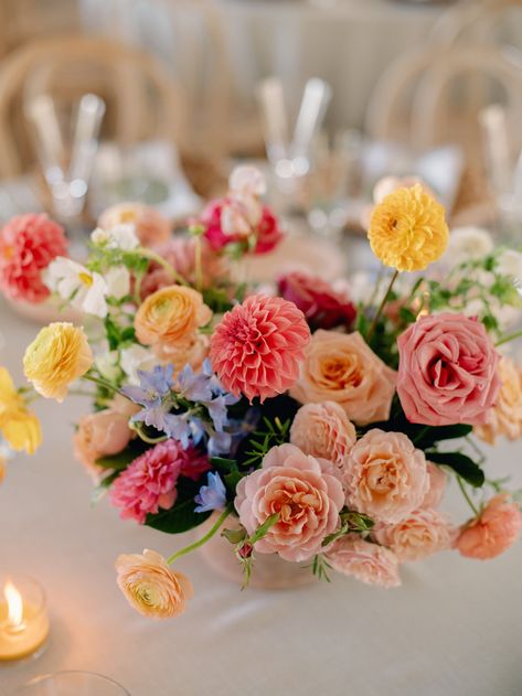 Summer centerpieces full of color with coral dahlias, peach garden roses, ranunculus and blue flowers. Peach Coral Blue Wedding, Summer Wedding Flowers Bouquets, Dusty Blue And Peach Wedding Theme, Peach And Blue Wedding Flowers Centerpieces, Orange Pink Coral Wedding Flowers, Head Table Wedding Flowers, Peach And Orange Floral Arrangements, Pink Peach Flower Arrangement, Peach Pink Yellow Wedding Flowers