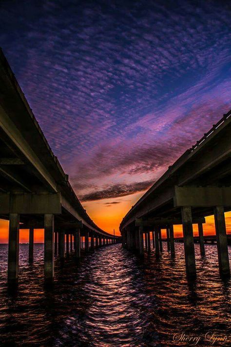 LAKE PONTCHARTRAN CAUSEWAY BRIDGE.....Mandeville to New Orleans, Louisiana....composed of two parallel bridges crossing Lake Pontchartrain....longest bridge over water in the world....the longer of the two bridges is 23.83 miles long.....supported by 9,500 concrete pilings.....opened in 1956.... operates as a toll bridge Bridge Over Water, Louisiana History, Louisiana Travel, Lake Pontchartrain, Sea To Shining Sea, Dream Photography, Kid Friendly Trips, Lake Sunset, New Orleans Louisiana