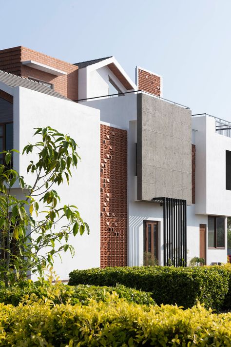 White walls and exposed brick highlight this Bangalore home's design | Architectural Digest India Boundary Wall Ideas, Boundary Wall Designs, Aesthetic Home Kitchen, Pathway Design, House Paint Colors, Boundary Wall, Compact House, Modern Exterior House Designs, Brick Architecture