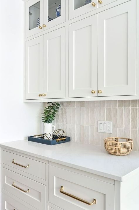 A glazed ceramic backsplash tile running vertically is elegant and simple. White Backsplash Kitchen Subway Tile, White Cabinets Ivory Backsplash, White Cabinets With Tan Backsplash, Tile In Kitchen Wall, White Backsplash White Countertops, Kitchen Tiles For White Kitchen, Glazed Backsplash Kitchen, European Style Backsplash, Cream Backsplash White Cabinets