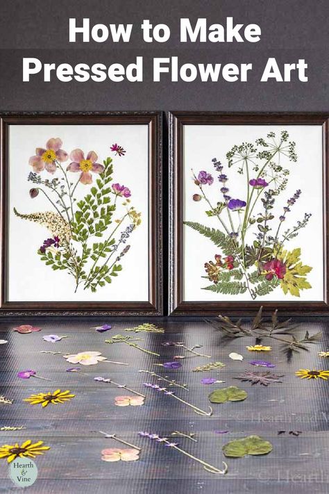 Two pressed flower art framed pictures with more pressed flowers on a table.