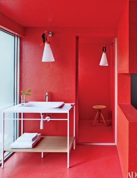 Red Bisazza tile lines a bath of a São Paulo home designed by the Campana brothers; the light fixtures are by Konstantin Grcic for Flos, and the vanity, sink, and fittings are by Antonio Lupi. Bright Color Bathroom, Colorful Bathrooms, Bathroom Red, Stunning Bathrooms, Bathroom Color, Red Walls, Bathroom Colors, Red Interiors, Modern Bathroom Design