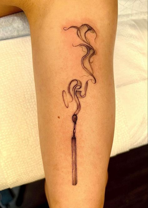 Tattoo of a half burnt match with smoke rising from it in a ribbon style placed on a person’s lower leg Two Matches Burning Tattoo, Burning Match Tattoo Design, Tattoos Of Fire, Burning Paper Tattoo, Burned Match Tattoo, Hands Holding Fire Tattoo, Smokey Match Tattoo, Matchstick Tattoo Meaning, Match Burning Tattoo