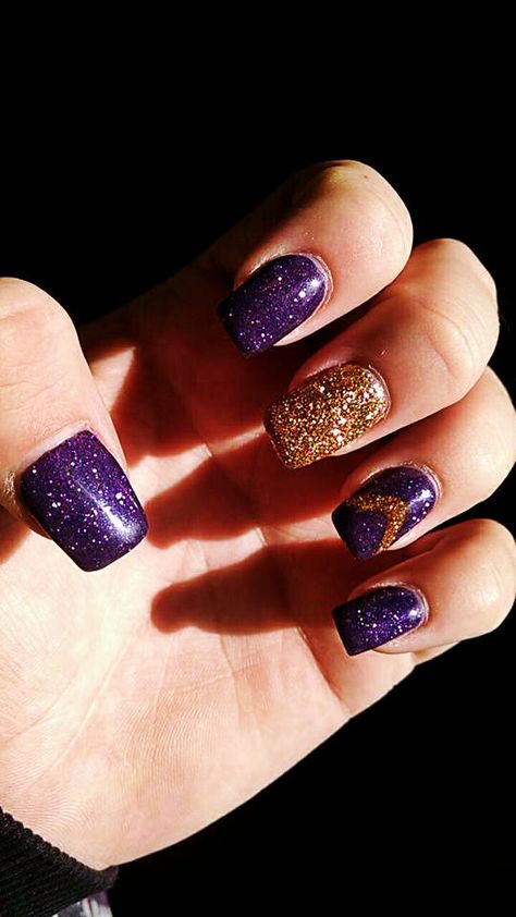 Purple and Gold Nails. #purple #purpleglitter #gold #goldglitter #glitterynails #accent #accentnails #purpleandgold #acrylic #acrylics #acrylicnails #nailsonfleek #glitter #awesomenails #nailsbycasie Black Purple And Gold Nails, Purple And Rose Gold Nails, Deep Purple And Gold Nails, Purple And Gold Nails Designs, Purple And Gold Dip Nails, Purple And Gold Gel Nails, Purple Nails With Gold Accent, Purple N Gold Nails, Purple And Yellow Nails