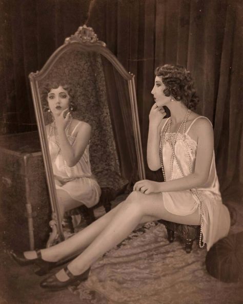 Sitting At Vanity Pose, Looking At Mirror Aesthetic, Woman Looking In Mirror Painting, Looking In Mirror Pose Reference, Woman Looking In Mirror Art, Person Doing Makeup In Mirror, Vintage Mirror Photoshoot, Mirror Reference Pose, Standing In Front Of Mirror Reference