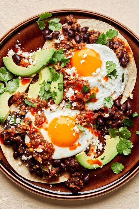 Runny, fried eggs over a bed of seasoned beans, atop a layer of warm corn tortillas, add a few condiments and voilà! Homemade huevos rancheros! Seasoned Beans, Huevos Rancheros Recipe, Eggs Fried, Simple Dinners, The Modern Proper, Modern Proper, Low Glycemic Diet, Fried Eggs, Fall Dinner