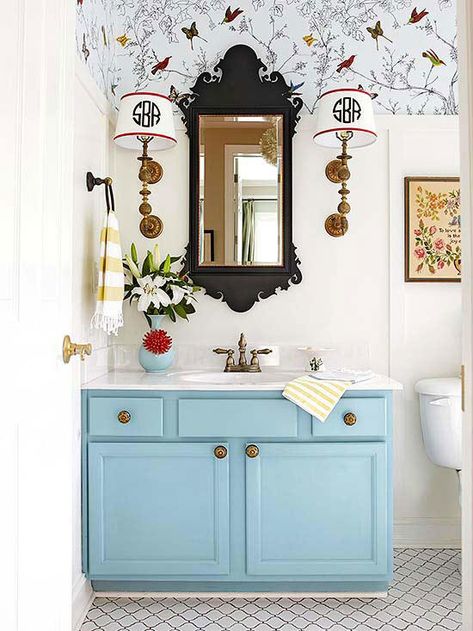 With a coat of soft blue paint and new hardware the bathroom instantly feels brighter, while the DIY paneling creates architectural interest. An intricate black mirror and a pair of sconces with customized shades help this bathroom feel special. Soft Blue Paint, Painting Bathroom Cabinets, Vanity Makeover, Bathroom Vanity Makeover, Master Bathrooms, Diy Vanity, Mirror On The Wall, Ideas Hogar, Gorgeous Bathroom