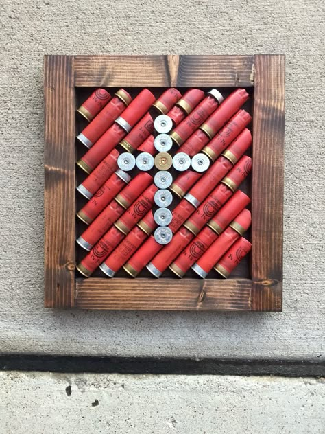 DIY project. All you need is: wood, nails, hammer, wood stain, empty shotgun shells, and some hot glue Bachelor Pad Wall Art, Shotgun Shell Art, Shell Casings Crafts, Bullet Casing Crafts, Shotgun Shell Crafts, Hunting Crafts, Bullet Crafts, Bullet Art, Padded Wall