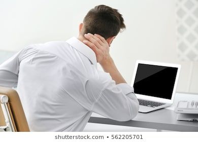 Man suffering from neck pain in office  photo Royalty free images stock