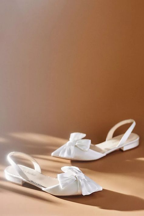 Bella Belle Reilly Slingback D'Orsay Bow Flats | Anthropologie Flat Wedding Dress Shoes, Flats With Wedding Dress, White Wedding Flats For Bride, Flat Shoes For Bride, White Bridal Flats, Wedding Shoes Bride Flats, Bridal Flats Shoes, Flat Wedding Shoes For Bride, Bow Flats Shoes