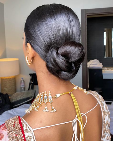 One of my favessss!! 🥨 Loved how elegant and sleek this was to go with the whole look for Shree’s wedding day Bridal makeup @_beautybyami Outfit @frontierraasuk Jewellery @thejewellerytrunk_ #weddinghair #wedding #bridalhair #bride #weddingdress #weddingmakeup #weddingphotography #weddingday #weddinginspiration #hair #bridalmakeup #updo #hairstylist #makeup #hairstyle #hairstyles #bridetobe #makeupartist #bridal #bridesmaids #weddings #love #weddinghairstyle #weddinghairstyles #weddingp... Sleek Bun Indian, Bridal Bun Front View, Indian Wedding Hairstyles Buns, Indian Updo Hairstyles, Upswept Hairstyles, Indian Bridal Bun, Day Bridal Makeup, Wedding Hair Bun, Sleek Chignon