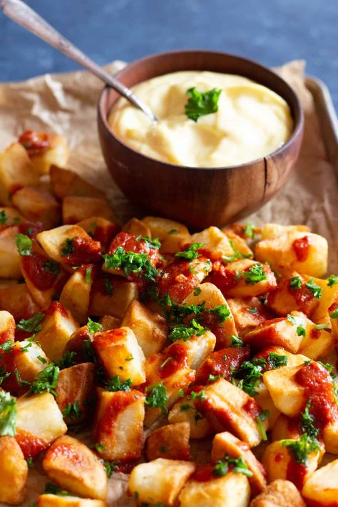 This Spanish patatas bravas recipe is a keeper! The potatoes are crispy on the outside and tender on the inside thanks to a simple technique to minimize use of oil and get super crispy and tasty potatoes! Recipe for patatas bravas sauce is also included, and you can serve these with some homemade aioli as part of a Spanish tapas spread! Papas Bravas Recipe, Easy Patatas Bravas Recipe, Spanish Dinner, Tapas Dinner, Homemade Aioli, Spanish Tapas Recipes, Tapas Dishes, Tapas Recipes, Spicy Tomato Sauce