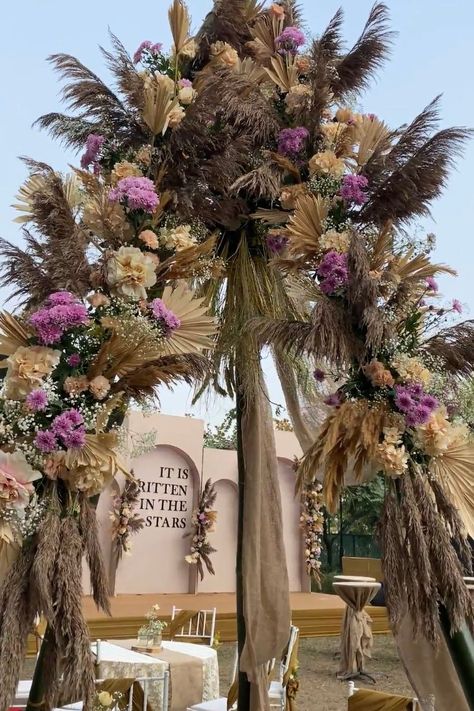 wedding decor using pampas grass Boho Themed Engagement Party, Boho Mehndi Decor, Boho Engagement Party Decorations, Boho Indian Wedding Decor, Boho Entrance Decor, Bohemian Engagement Decor, Tropical Stage Decor, Boho Theme Indian Wedding Decor, Boho Mehendi Decor