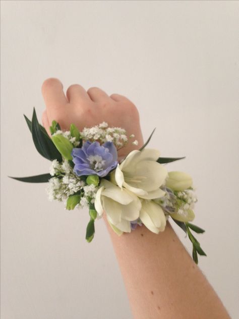 Pretty wrist corsage of Freesia and Delphinium Natural Corsage Prom, Flower Bracelet For Prom, Prom Hand Flowers Wrist Corsage, Formal Corsage Wristlets, Periwinkle Corsage Prom, Wristlet Corsage Prom, Forget Me Not Corsage, Floral Corsage Wrist, Prom Corsage Trends 2024