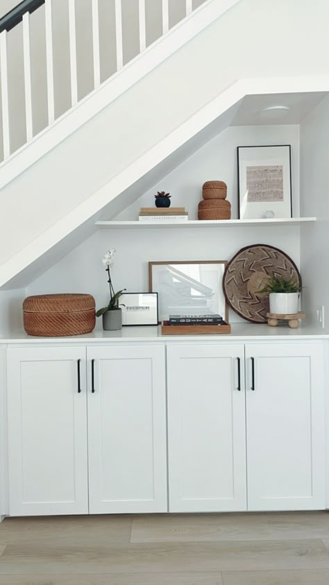 built-in storage under stairs Before & after photos of my client's home remodel in foothill ranch, ca. This portions shows the entryway, living room, kitchen, and powder bathroom. #onlineinteriordesign #interiordesign #californiacasual #homeremodel #homerenovation Upstairs Hallway Built Ins, Under Stair Built In Storage, Basement Storage Ideas Under Stairs, Modern Under Stairs Storage, Built In Stair Storage, Cottage Under Stairs Storage, Understairs Basement Storage, Under Stairs Storage Living Room, Understairs Ideas Living Room