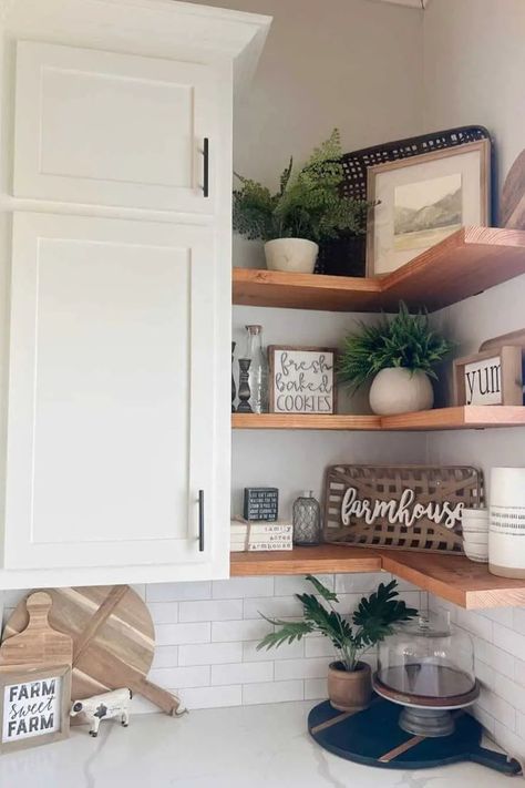 For added storage or to showcase your decorative items, consider adorning your kitchen corners with floating shelves. These space-saving shelves harmoniously align with your kitchen cabinets and create an alluring backdrop over the backsplash. The color and material of the shelves can further enhance your existing decor. Kitchen Corner Shelf Decor, Kitchen Corner Decor Ideas, Corner Kitchen Shelves, Corner Shelves Kitchen, Kitchen Corner Ideas, Corner Shelf Decor, Kitchen Corner Shelves, Kitchen Corners, Hastings House