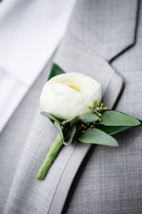 This boutonniere feature White Ranunculus and Seeded Eucalyptus. A classic combination that looks fantastic with any suit color!  Photographer: @kairosphotographystl  Visit our website (www.wildflowersstl.com) to book a consultation for your upcoming wedding. And don’t forget to check out our Instagram for new posts every weekday! @wildflowersstl Small White Boutonniere, Bridal Bouquette, White Peony Boutonniere, White Boutonniere Wedding, Groom Buttonhole White, White Ranunculus Boutonniere Wedding, Simple Wedding Boutonniere, Groom Boutonniere Ranunculus, Groom Boutonniere White Peony