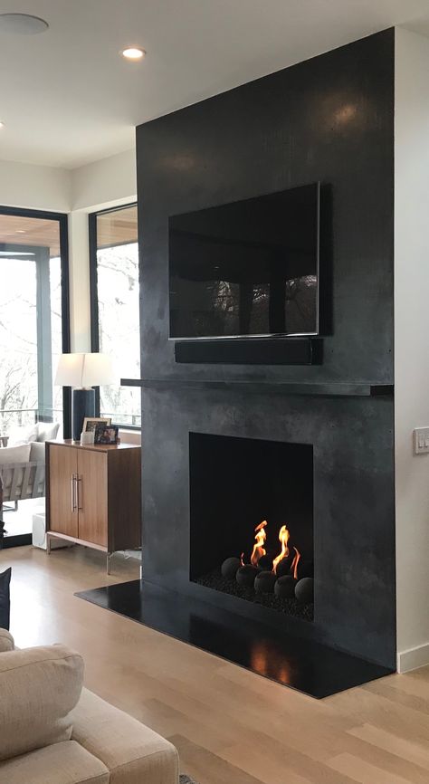 Black Wall And Fireplace, Black Drywall Fireplace, Fireplace Ideas Industrial, Black Faux Concrete Fireplace, Matte Black Fireplace Wall, Black Fireplace Small Living Room, Limewash Black Fireplace, Black Bedroom With Fireplace, Black Living Room With Fireplace