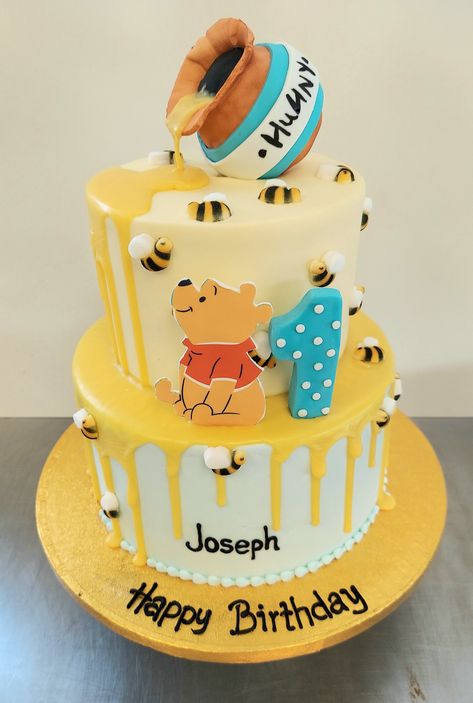 2-tier Winnie-the-Pooh cake for a first birthday. Iced in buttercream with ganache drip, fondant honey pot and a printed (edible) Winnie-the-Pooh from DecoPac. #customcakes #firstbirthday #1stbirthday #winniethepooh Pooh Theme Cake, Disney Theme Cake, Pooh Smash Cake, Winnie The Pooh Smash Cake, Winnie The Pooh Cakes, 1st Bday Cake, Tiered Cakes Birthday, Winnie The Pooh Cake, Baby First Birthday Cake