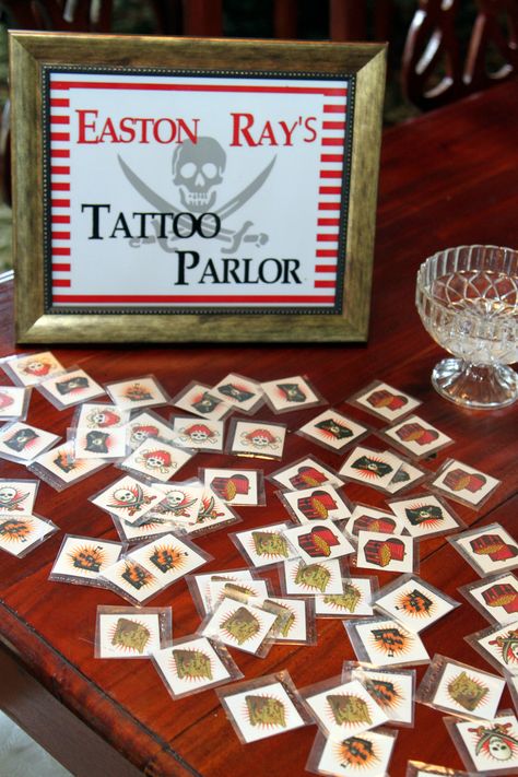 Easton's tattoo parlor from his pirate party #pirate #pirateparty #tattoo Pirate Tattoo Parlor, Tattoo Parlor Pirate Party, A Pirates Life Four Me Party, Pirate Themed 4th Birthday Party, Pirate Food Labels, Pirate Party Invitations Printable, Ray Tattoo, Pirate Tattoo, Pirate Theme Party