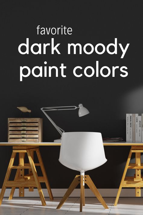 A wood desk with a white chair in front of a dark black moody painted wall Dark Moody Paint Colors Benjamin Moore, Best Dark Wall Colors, Moody Dining Room Paint Colors, Sherwin Williams Moody Colors, Moody Office Paint Colors, Dark Moody Paint Colors, Dark Moody Office, Moody Paint Colors, Moody Paint