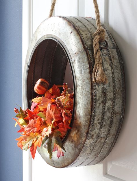 Simply swap out the floral stems in this metal tire wreath for every season of the year Fall Tire Decorations, Tire Wreath, Metal Wreaths, Tire Ideas, Spring Wreath Tutorial, Tire Craft, Tire Planters, Tire Shop, Tire Art