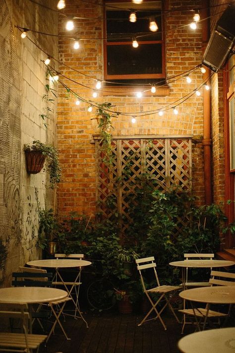 Create your own cozy cafe using string lights and a basic bistro set! Backyard Cafe, Outdoor Restaurant Patio, Rustic Cafe, Cafe Seating, Restaurant Patio, Patio String Lights, Bistro Lights, Cafe Bistro, Outdoor Cafe