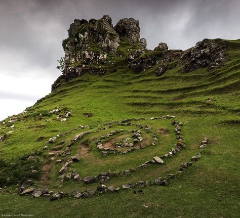 This is a natural rock formation called Castle Ewen in a magical place called the Fairy Glen. It is on the Isle Of Skye near Uig. The spiral of stones you can see in front of the 'castle' is obviously man made. I saw some people there attempting to walk from the outside to the centre by walking backwards. Apparently you are not to touch the stones when doing so. I am going to guess that would bring you bad luck. Magic Rocks, Fae Aesthetic, Howleen Wolf, Fairy Glen, Disney Brave, Natural Rock, Breath Of The Wild, Isle Of Skye, Laura Lee