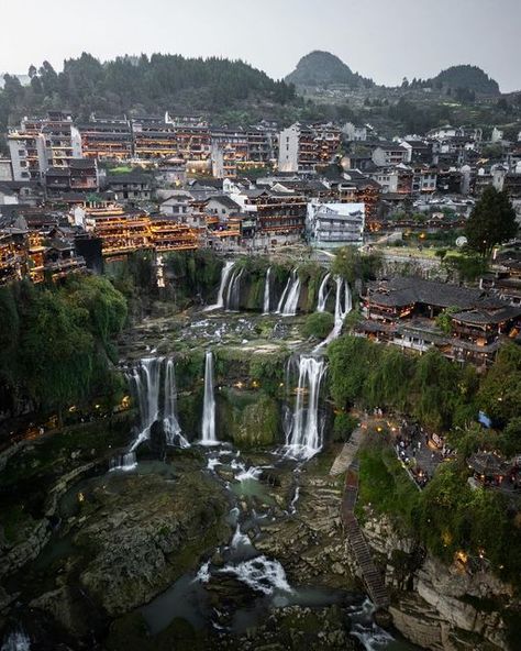 BeautifulChina on Instagram: "Welcome to the beautiful Furong Ancient Town, one of the most magical places in China! 🇨🇳  After spending a few days exploring this enchanting town, I’m already eager to return—especially in a different season when the waterfall is at its most powerful. The town is full of hidden gems: cozy cafes, delightful restaurants, unique souvenir and gift shops, and historical buildings 💫  This place is also known as Hibiscus Town, and is famous for its picturesque waterfall cascading beside ancient buildings. This unique setting makes it a popular filming location for Chinese movies and TV dramas 📺 ▪️ #hellofrom #chinatravel #furong #hunan #芙蓉古镇  ——————————————————————— Photo by @kieranvisuals ———————————————————————— Selected by @shiushiu177 Tag @Chinadestinations China Destinations, Asia Trip, Historical Buildings, Gift Shops, Ancient Buildings, Travel Must Haves, Chinese Movies, Cozy Cafe, Different Seasons