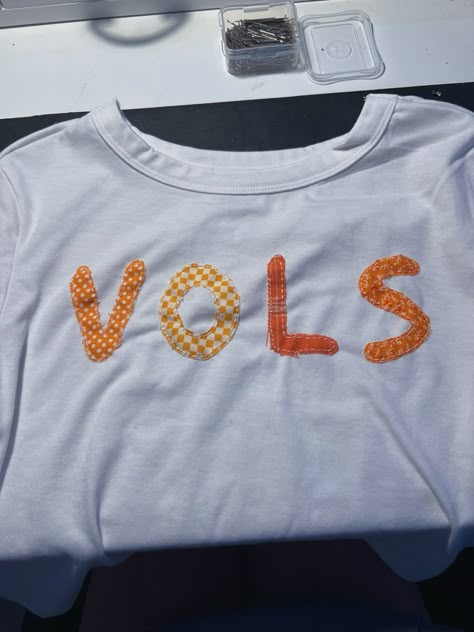 utk tennessee vols football baby tee embroidered patchwork letters hand stitch shirt diy inspo Country Concert Shirts Diy, College Gameday Shirts Diy, Patchwork Word Shirt, College Patchwork Shirt, Diy College Shirts, Diy Game Day Shirt College, Patchwork Letter Shirt, Diy College Merch, Patchwork Tee Shirt Diy