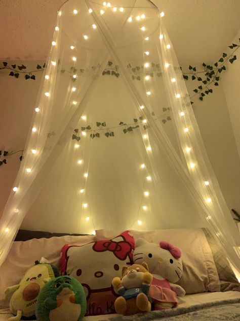 A white canopy above my bed. There are also spherical warm-white lights hanging on it. Canopy With Vines And Lights, Floral Bed Rooms, Canopy With Fairy Lights, Bed Canopy Lights, Canopy Above Bed, Things To Hang Above Bed, Mesh Bed Canopy, Curtains Above Bed, Bed Netting Canopy