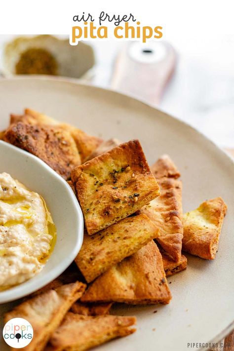 Craving a crunchy snack? Try these homemade air fryer pita chips! Made with just a few ingredients, they're crispy, flavorful, and ready in minutes. Use them to scoop up dips, crumble over salads, or munch on their own. The za'atar seasoning adds a unique taste, but feel free to experiment with your favorite spices. Perfect for using up leftover pitas too! Bread Air Fryer, Pita Chips Recipe, Homemade Pita Bread, Crispy Chips, Airfryer Recipes, Za Atar, Crunchy Snack, Air Fryer Healthy, Pita Chips