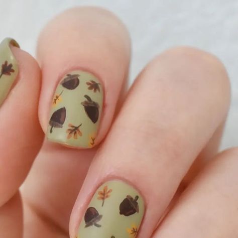 Nail Art by Amber on Instagram: "🌰 🍂 Just a simple little acorn and fall leaves design. I like how everything turned out, except on the thumb nail. For some reason, I kept the acorns and leaves very small. Even on my second try. Don't know why. Anyway, the weather is starting to cool down, and I couldn't be more excited for it. How about you all? . . . Products Used: @zoyanailpolish 'Ireland', 'Emilia', 'Dionne', 'Colin', 'Chanelle', 'Honey' . @essie 'Kaf-tan' . @sally_hansen Big Matte top co Acorn Nail Art, Acorn Nails, Fall Leaf Nail Designs, Fall Leaves Design, Plain Nails, Leaves Design, Autumn Nails, Sally Hansen, Fall Leaves