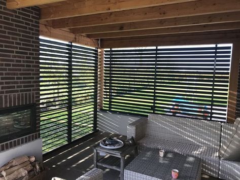 With two slatted walls, an outdoor space has been transformed into a porch. Inside and yet outside. You decide how much outside. That is a matter of setting the louvers in the desired position. This can be done manually here. #sunshield #louvers #louvres #blinds #shutters #customlouvers #exteriorblinds #externalblinds #venetianblinds #windowstyling #build #renovate #homeimprovement #garden #jalousien #lamellen #stores #bouwen #verbouwen Slatted Walls, Exterior Blinds, Venetian Blinds, Garden Room, Shutters, Outdoor Space, Blinds, Terrace, Matter