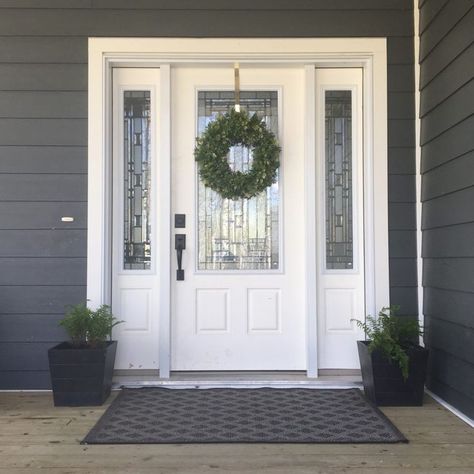 Grey Hardy Board Siding with white door. Ferns in planters on either side of door. Lovely farmhouse wreath and grey rug. (From blog Valley + Birch) White Door Decoration Ideas, Ferns In Planters, White Door Exterior, White Front Door Exterior, White Entrance Door, Kitchen Entry Door, Leadlight Doors, Hardy Board Siding, White Exterior Door