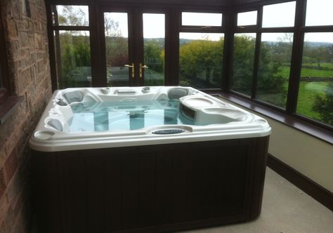 Sundance Spas 780 Series Montclair installed inside a conservatory.  These hot tub owners are able to relax and enjoy a stunning view from their hot tub.  The cabinetry of the spa is in mahogany to match the frame of the conservatory. Hot Tub In Conservatory, Deck Enclosures, Conservatory Ideas, Indoor Hot Tub, Hot Tub Patio, Florida Room, Backyard Furniture, The Spa, Hot Tubs