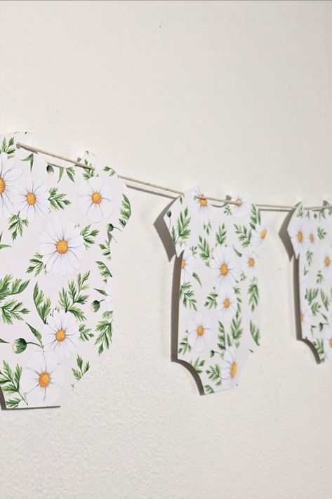 Celebrate your new arrival with this 'Baby in Bloom' Garland. Garland consists of 9 onesie cardstock cutouts on twine. Onesie Garland, Baby In Bloom, Baby Shower Banner, Floral Baby Shower, Flag Bunting, Floral Baby, In Bloom, Bunting, Twine