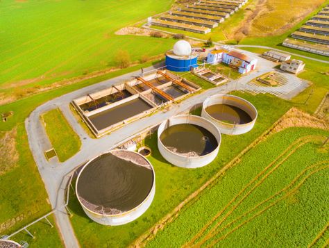 Aerial view to biogas plant from pig farm in green fields. Renewable energy from biomass. Biogas Plant, Biomass Boiler, Biomass Energy, Forms And Shapes, Pig Farm, Wood Waste, Gas Pipeline, Water Pollution, Pig Farming