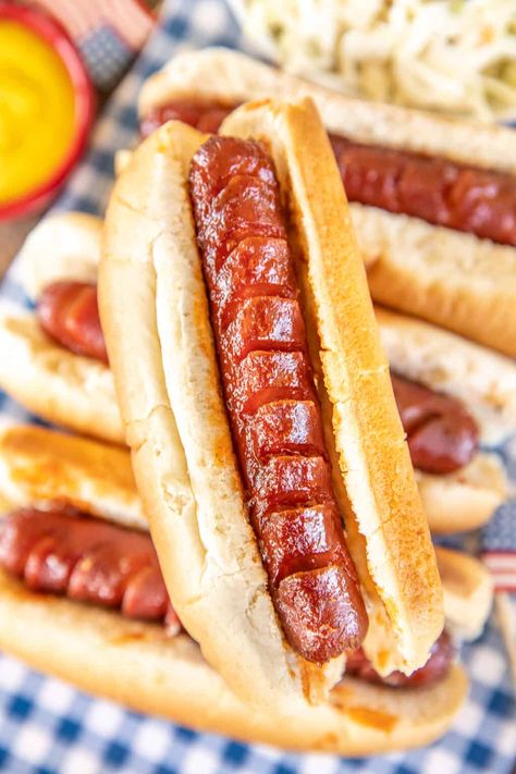 Slow Cooker BBQ Hot Dogs - the best hot dogs EVER! Super easy and they taste great! Hot dogs slow-cooked in a quick homemade sauce of ketchup, BBQ sauce, Worcestershire sauce, brown sugar, vinegar, and onion powder. Slice the hot dogs on two sides so they absorb more of the sauce - YUM! Great for cookouts, tailgating, and parties. #slowcooker #crockpot #hotdogs Hotdogs In Crockpot, Bbq Hot Dogs, Dogs Recipes, Field Meals, Ultimate Mac And Cheese, Bbq Sauce Homemade Easy, Best Baked Beans, Hot Dog Sauce, Grilling Hot Dogs