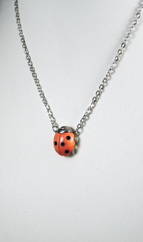 "I found this Orange Ladybug on silver plated in our Vintage Vault and couldn't believe it!   I have never seen this combination of orange and silver plated in a Vintage Ladybug before!!      Usually these ladybugs come in gold toned!!    These are the most ADORABLE necklaces ever! These little Vintage ladybugs from the 1970's come in multiple colors and are just precious!  Nearly all cultures believe that a ladybug is LUCKY! \"Ladybug Legends\" included with every purchase! Get your Lucky Ladyb Ladybug Necklace, Marbled Resin, Bug Jewelry, A Ladybug, Dope Jewelry, Funky Jewelry, Jewelry Inspo, Dream Jewelry, Lady Bug