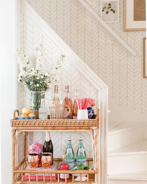 Rattan bar carts to usher in the cocktail hour. The bar carts in use today reemerged in the 50s and 60s—the era of cocktail parties. Bar Cart Inspo, Bar Cart Essentials, Cocktails Cart, Apartment Bar, Rattan Bar Cart, Boho Bar, College House, Bar Cart Styling, College Apartment Decor