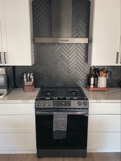 Matte black herringbone kitchen backsplash, white shaker cabinets. Black Stacked Backsplash, Black Backsplash Wood Countertop, Black Matte Backsplash Kitchen, Black Backsplash Black Grout, White Subway Tile Kitchen Backsplash With Black Accent, Black Kitchen Black Backsplash, Black Kitchen White Backsplash, Black Matte Backsplash, Matte Black Herringbone Backsplash