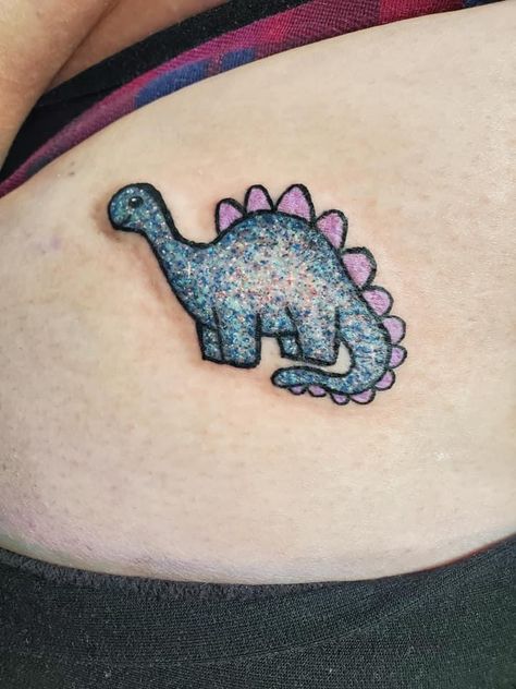 #glittertattoo #glitter #dinotatto #tattoo #tattooideas Cute Dinosaur Tattoo Ideas, Small Glitter Tattoo, Glow Worm Tattoo, Cute Dino Tattoo Ideas, Girly Dinosaur Tattoo, Glitter Ghost Tattoo, Glitter Style Tattoo, Womens Dinosaur Tattoo, Pretty Poison Tattoo