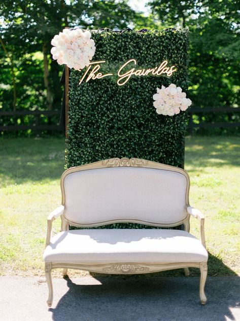 Beautiful green backdrop with an accent couch add your special color to make it unique to your event! Also loving the neon sign!! Photographer: Arielle Peters Wedding Reception Photo Booth, Reception Photo Booth, Accent Couch, Folding Garden Chairs, Southwest Michigan, White Linen Napkins, Above Couch, Venue Rental, Green Backdrops