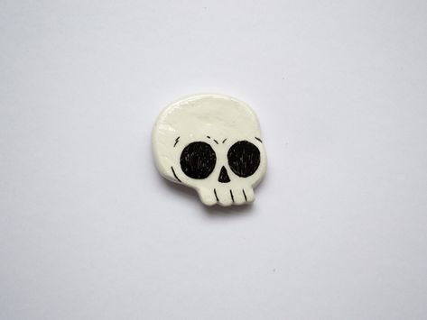 A hand sculpted skull clay pin. Perfect for those looking for a cool hand crafted accessory. Sculpted by hand with fimo clay, painted and sealed with a gloss resin varnish. Features a butterfly clasp on the rear. As each pin is made and finished by hand, there may be minor cosmetic differences between each pin. Seal Clay Sculpture, Clay Badges, Clay Pins Diy, Fimo Art, Clay Pin Ideas, Air Dry Clay Pins, Clay Skull, Ceramic Pins, Clay Sculpting