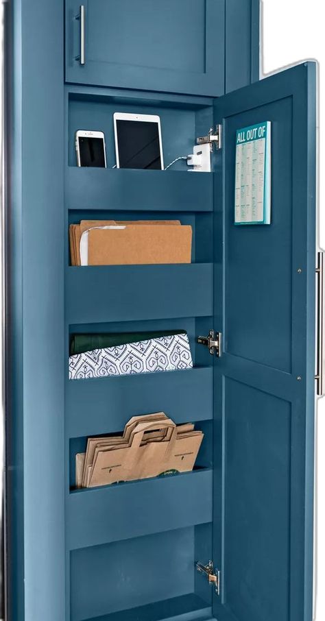 Transform a blank wall in the kitchen into a hidden storage compartment. These homeowners outfitted the narrow space along the side of the refrigerator with shallow shelves that store paper bags, homework, folders, and tablets (there's even an outlet for charging devices).#homeorganization #commandcenterideas  #organizationhack #bhg Shallow Kitchen Wall Storage, Space Above Refrigerator Ideas, Narrow Space Next To Refrigerator, Narrow Upper Cabinet Storage Kitchen, Narrow Wall Book Storage, Narrow Storage Wall 6 Inches, Space Above Refrigerator, Above Refrigerator Ideas, Cubby Storage Bins