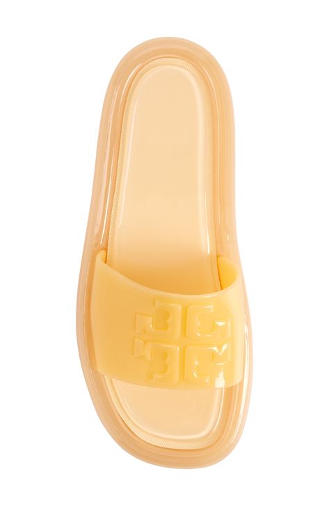 A semi-transparent sole grounds this playful slide sandal topped with a logo-detailed vamp strap. 1" heel; 3/4" platform (size 9) Synthetic upper and lining/rubber sole Imported Tory Burch Slides Outfit, Tory Burch Bubble Jelly, Tory Burch Jelly Sandals, Tory Burch Slides, Shopping Addict, Slides Outfit, Jelly Slides, Peach Puff, Wardrobe Room