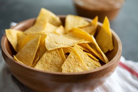 Crispy and salty, these Homemade Tortilla Chips are so easy to make and so much better for you than store bought. They are the perfect afternoon snack. #recipe #homemade #tortillachips #snack Queso Dip Mexican, White Corn Tortillas, Cheese Dip Mexican, Tortilla Chip Recipe, Baked Tortilla Chips, Homemade Tortilla, Cranberry Salsa, Fried Chips, Homemade Salsa Recipe