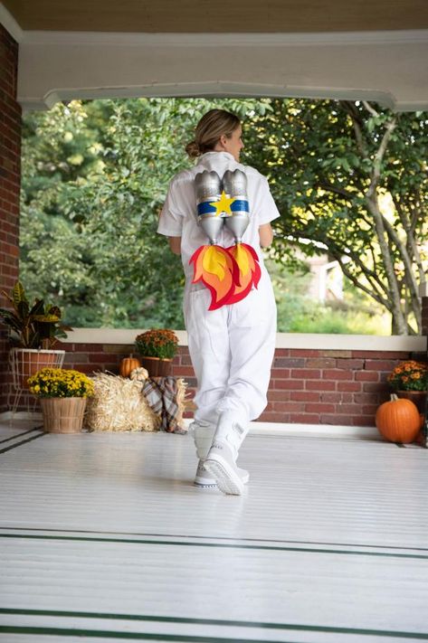 Dreaming of leaving this world behind and laying down roots on Mars? We relate. This last-minute DIY Astronaut costume isn’t quite space-ready, but it’s certainly fit for your upcoming Halloween festivities here on Earth. Build your jet pack with two recycled 2-liter bottles painted metallic silver, and add blue-and-white stripes for a quintessential rocket appeal. Ready for blast-off? Glue red, yellow and orange felt flames to the base of your jetpack to take off and fly into the night. Diy Astronaut Costume, Astronaut Diy, Astronaut Halloween Costume, Outer Space Costume, Astronaut Halloween, Alien Halloween Costume, Handmade Halloween Costumes, Space Costumes, Dollar Store Halloween Decorations