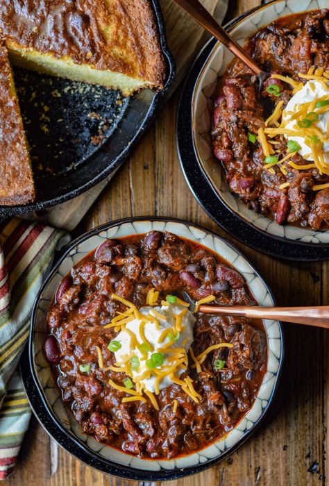 The complexity of flavors in this Beef Short Rib Chili make it the ultimate comfort food. Dried Ancho and California chile peppers are the keys to its depth and intensity. Chocolate and Coffee, the secret ingredients, add to its richness. Top it off with tender chunks of meat that just about melt in your mouth. #beefchili #shortribchili #onepotmeals #beefshortribs #comfortfood Rib Chili Recipe, Short Ribs Chili Recipe, Sausage Chili Recipe, Short Rib Chili, Chili Contest, Chili Dinner, Chile Peppers, Chocolate And Coffee, Sweet Cornbread